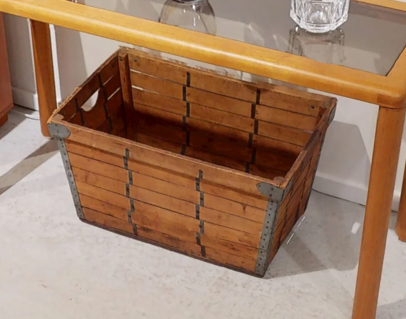 Weathered wooden slatted storage crate with metal corner brackets